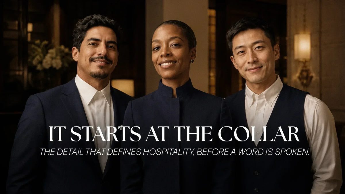 Luxury hospitality professionals wearing premium navy hotel uniforms showcasing distinctive collar styles designed by JA Uniforms for luxury hotels in South Florida and the Caribbean.